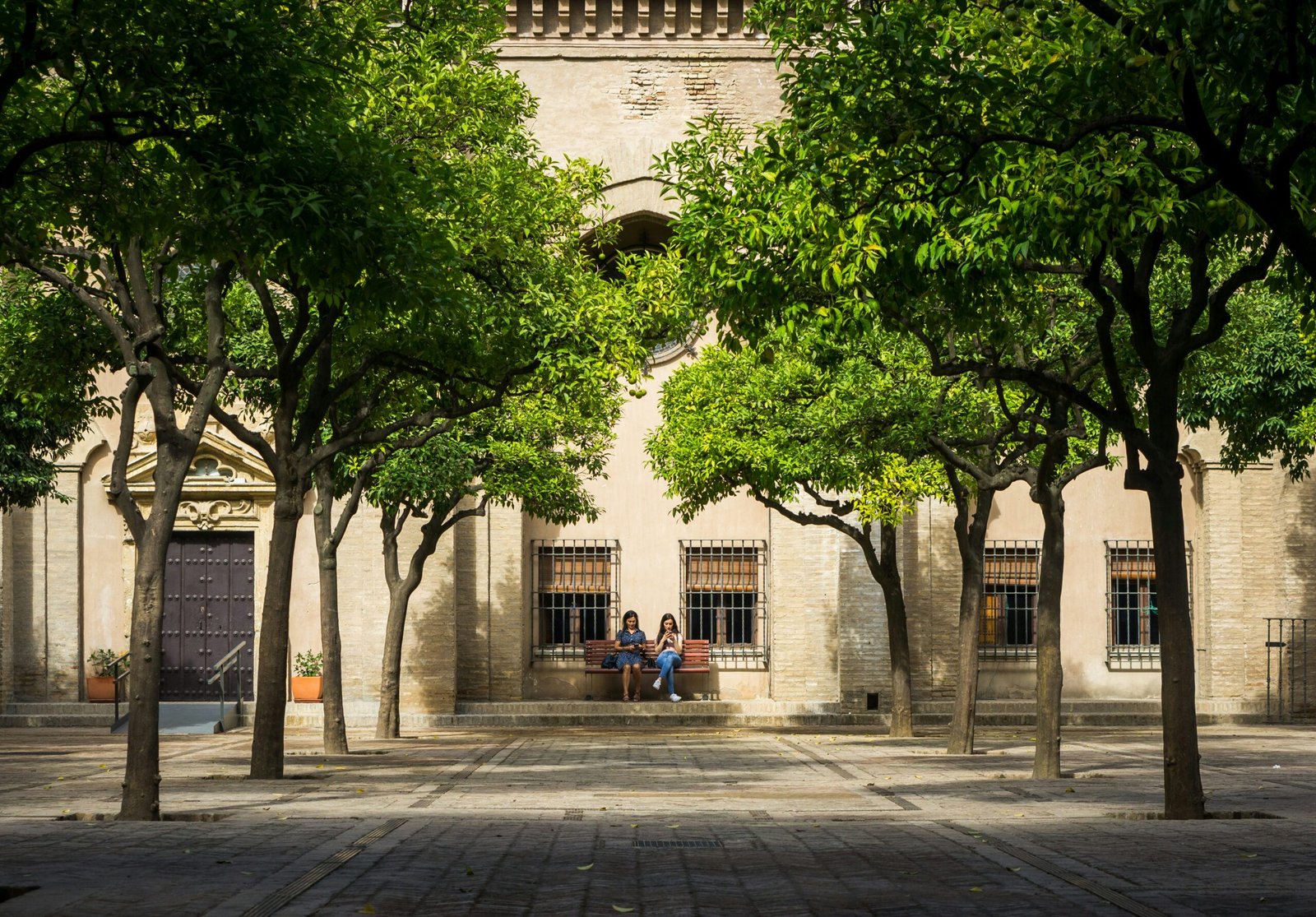 Students sitting in a courtyard at a Spanish university campus